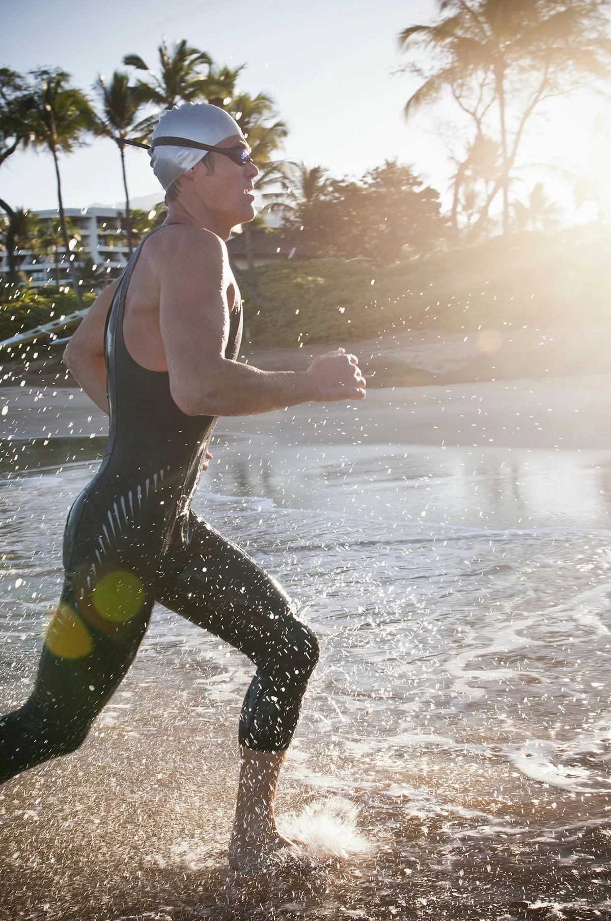 swimmer running in waves on beach